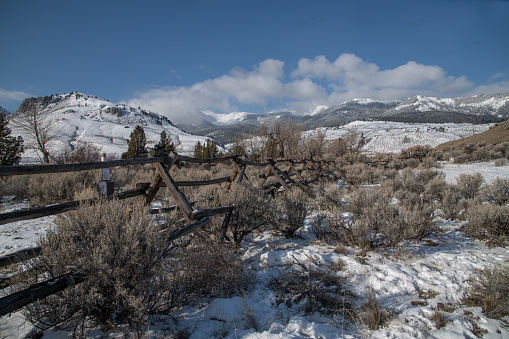 Yellowstone park bison hunting area near Gardiner, Montana USA. Fence marks entrance to permitted bison hunting area.