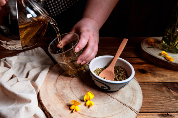 istock Male making hot tea using natural herbs in the kitchen 1478422854