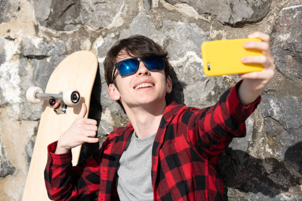istock Cool teenager boy taking selfie 1478424176