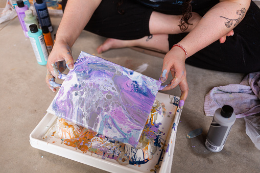 Woman Painting - Sitting on Floor - Acrylic Pour Abstract Art - Purple, White, Blue, Grey