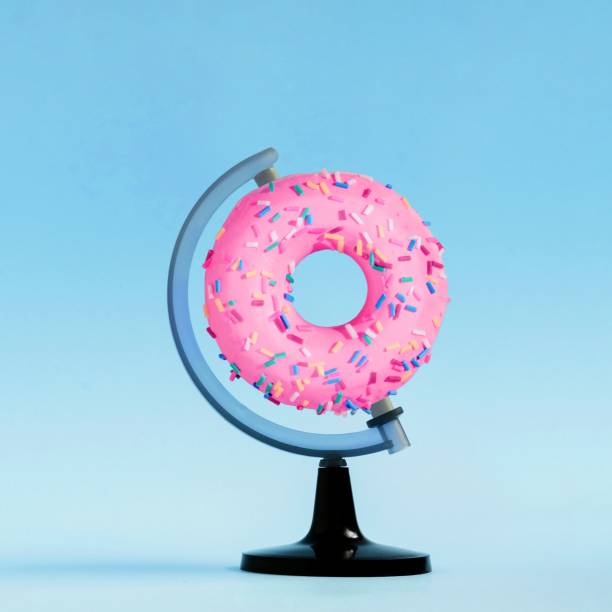 istock 3D rendering of a creative composition of a donut on a globe stand with a blue background 1478427969