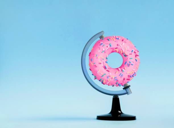 istock 3D rendering of a creative composition of a donut on a globe stand with a blue background 1478427974