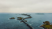 Aerial view of cars driving scenic Atlantic Ocean Road in Norway