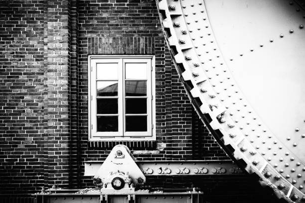 millwheel in front of a window on a brick wall - european culture ancient architecture still life imagens e fotografias de stock