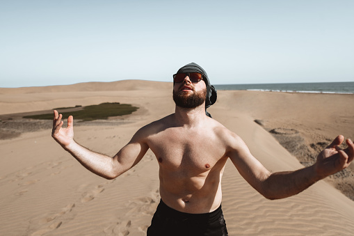 Bearded Male Taking In The Sunlight While Walking The Sand Hills Of Maspalomas Gran Canaria, Spain