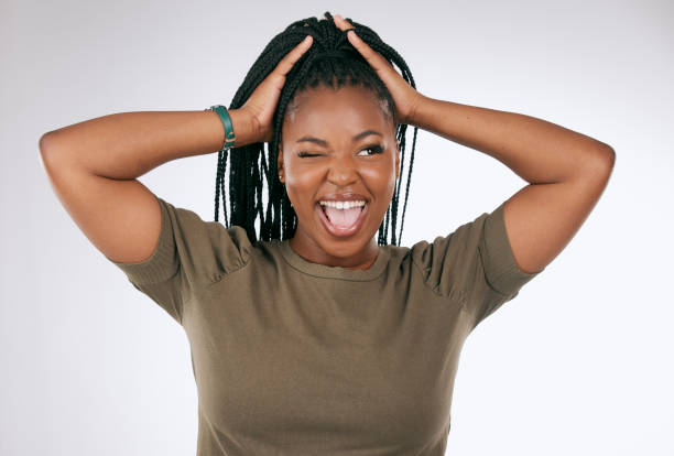 istock Comic, funny and black woman with a crazy face isolated on a grey studio background. Smile, happy and African girl model with tongue sticking out for comedy, happiness and goofy on a backdrop 1478438011