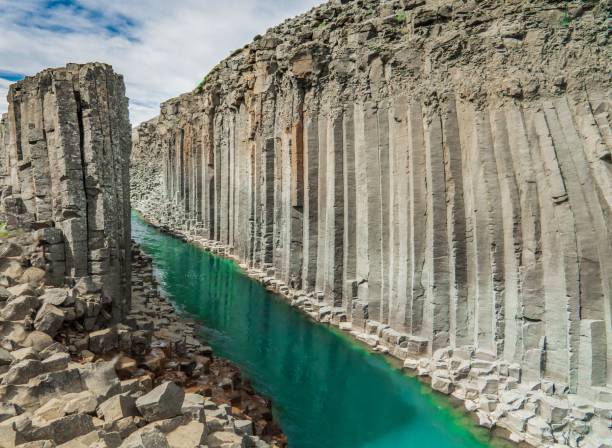 istock Studlagil canyon with hexagon tones and a green water stream during the daytime 1478439901