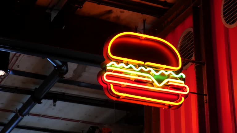 Bright generic burger place, fast food restaurant neon sign, signage, colorful neon ad closeup, burger sandwich symbol retro style, night life, bars and gastronomy advertisement concept, nobody