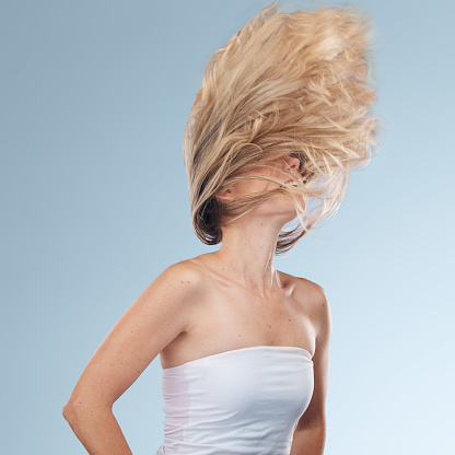 Hair, beauty and woman in studio happy dance and head shake fun on grey background mockup space. Haircare, girl and model relax with luxury, wellness and grooming, hygiene and pamper while isolated