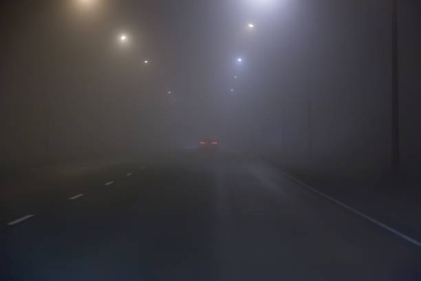 istock Car fog on road lit by lamps 1478443781