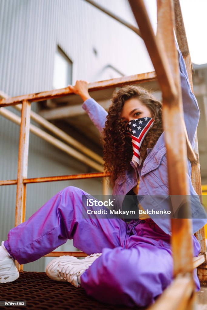 Cool dancer on the street  with american bandana dancing. Cool dancer on the street in stylish clothes with american bandana dancing. young dancing woman showing some moves. 25-29 Years Stock Photo