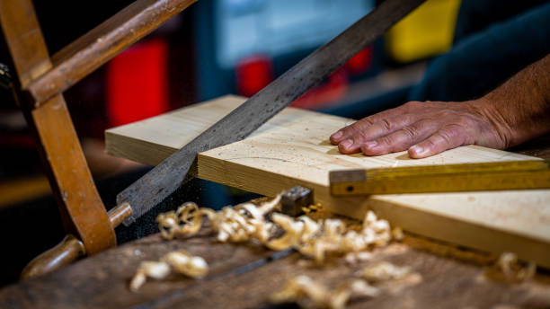 istock Male carpenter cutting wooden plank 1478446276