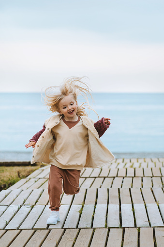 Child girl running on the beach kid 4 years old happy emotions family vacations lifestyle travel outdoor