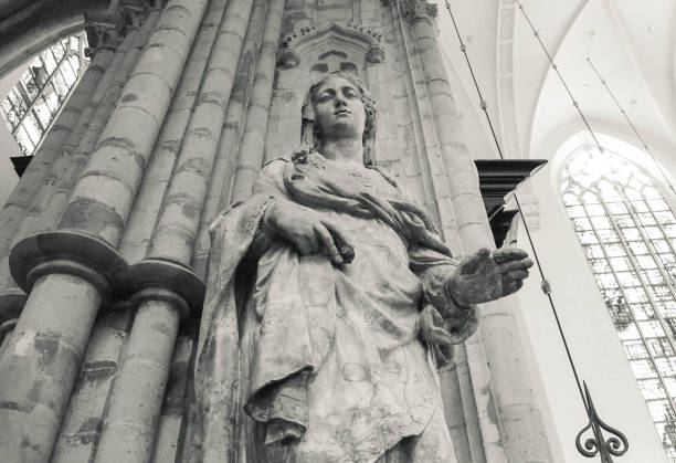 istock Holy Mary Virgin Big Stone Statue in Brussels Cathedral from Below with Columns Behind (B&W) 1478450489