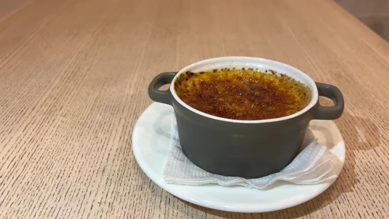 Chef cooks creme brulee with gas burner, dessert in the home kitchen, Cooking at home, professionals for food blog