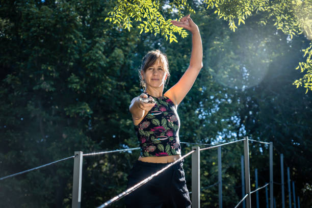 istock Woman practising tai chi with a sword on a bridge. 1478451797