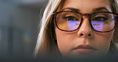 Serious woman, face or glasses for screen reflection in software coding, ux programming or digital website planning at night. Closeup, programmer or developer with vision eyewear for late technology