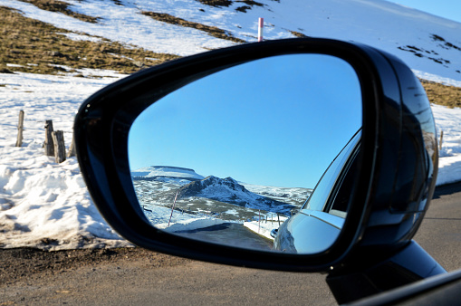 Traffic behind a car as seen from a side view mirror