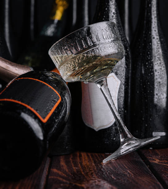 different bottles of champagne with a glass of white champagne stock photo