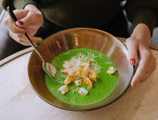 Broccoli green cream soup with shrimps