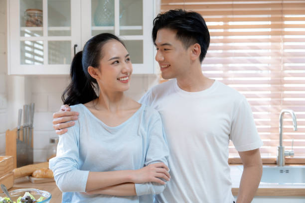 istock Happy asian couple hugging and smiling. 1478463052