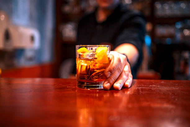 istock Bartender serving a cocktail drink on a bar counter 1478463676