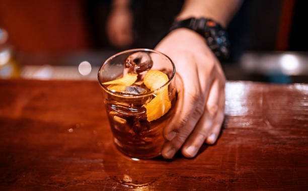 istock Bartender serving a cocktail drink on a bar counter 1478463744