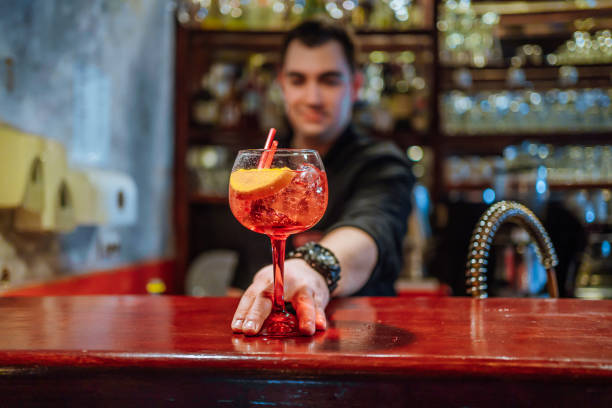 istock Bartender serving a cocktail drink on a bar counter 1478463794