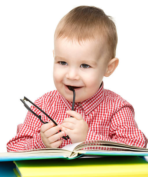 istock Little child play with book and glasses 147846872
