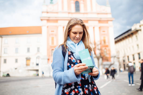 mature woman with map in venice, italy. beautiful woman having fun traveling outdoors during vacation in europe - travel outdoors tourist venice italy imagens e fotografias de stock