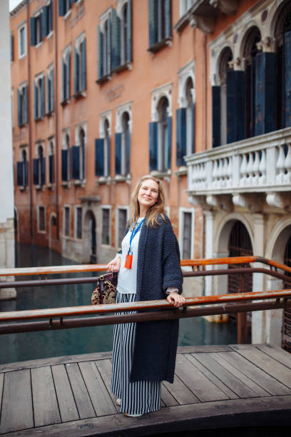 mature woman with map in venice, italy. beautiful woman having fun traveling outdoors during vacation in europe - travel outdoors tourist venice italy imagens e fotografias de stock