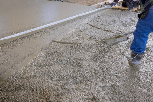 istock The concrete was poured on of a wet cement sidewalk by a construction worker using long trowels to level the concrete as it was poured. 1478481373
