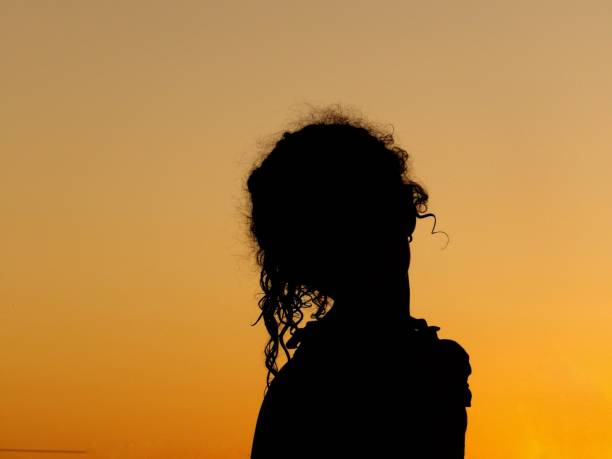istock girl silhouette at sunset 1478482403