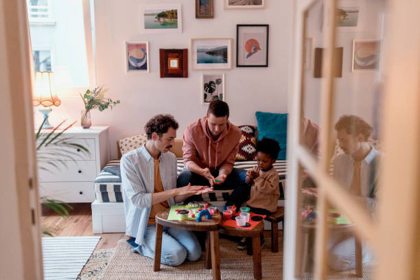 istock Casually dressed gay parents being creative with their son 1478484967
