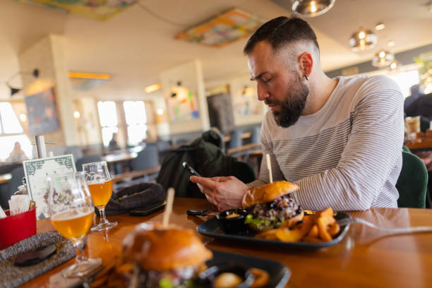 istock Delicious Burgers are Waiting While He Finishes Texting 1478485259