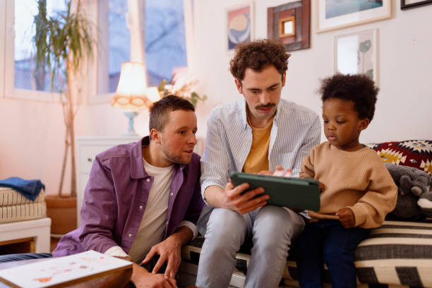 istock Gay couple using modern technology with their son 1478485522