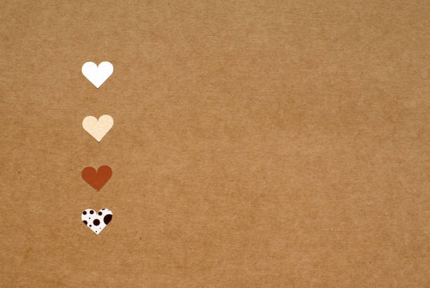 four small hearts on brown craft paper background