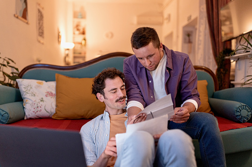 Two male partners doing paperwork from home