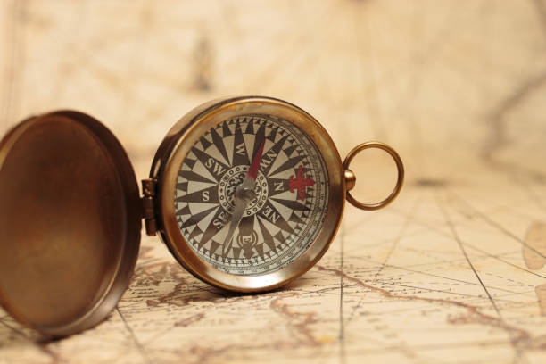 istock Magnetic compass on a world map. Travel, geography, navigation concept background. 1478501972