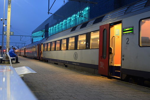 Blankenberge, West-Flanders, Belgium - March 29, 2023: NMBS Belgian rail road station end stop Blankenberge. Open doors illuminated train waiting departure time direction Brussels end station Hasselt city.