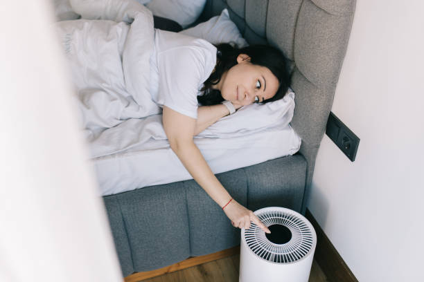istock Woman is turning on air purifier in bedromm 1478503399