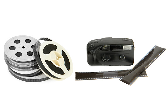 Old camera, film and Film reel isolated on white background. Collage. Free space for text. Wide photo.