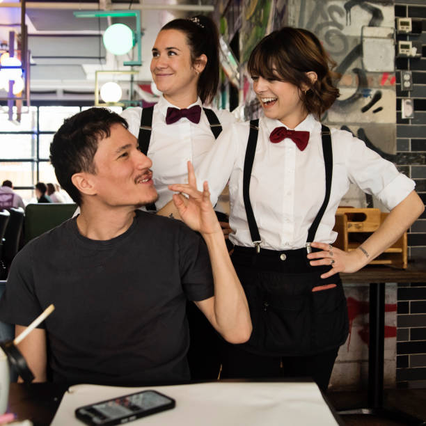 young female waitress dancing and carrying an empty tray