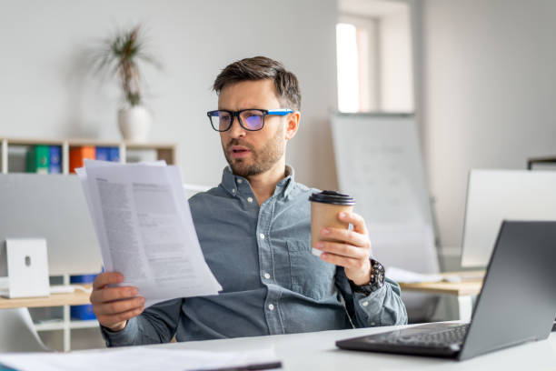 istock Concentrated middle aged businessman analyst manager working with documents and papers at workplace in office 1478505469