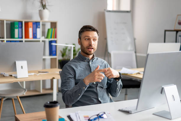 istock Video conference. Portrait of mature businessman having web call using modern computer while sitting at workplace 1478505697