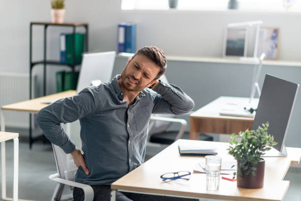 istock Mature businessman massaging aching neck and back, suffering from pain after computer work, sitting at workplace 1478506100