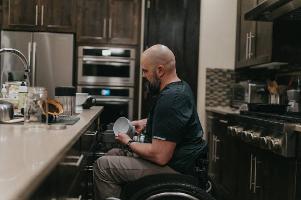 istock Man putting clean dishes away in kitchen 1478508091