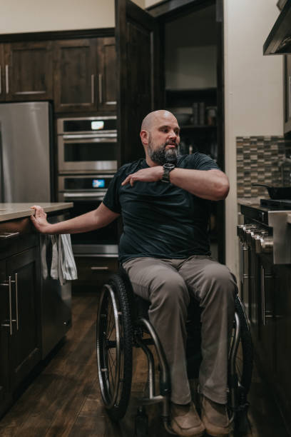 istock Man in wheelchair at home in the kitchen 1478508095