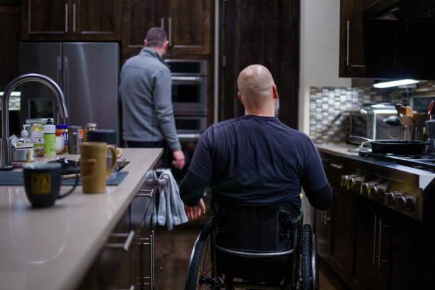 istock Man with a disability preparing a meal at home 1478508134