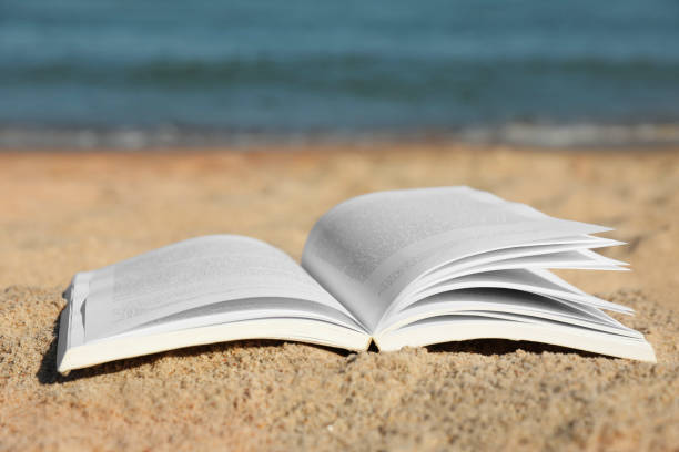 istock Open book on sandy beach near sea 1478509088
